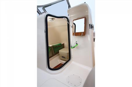 Slide: The Image of 2016 Grady-White Freedom 225 cabin interior with seating and storage. - 4
