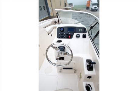 Slide: The Image of 2016 Grady-White Freedom 225 boat cockpit with steering wheel and control panel. - 5