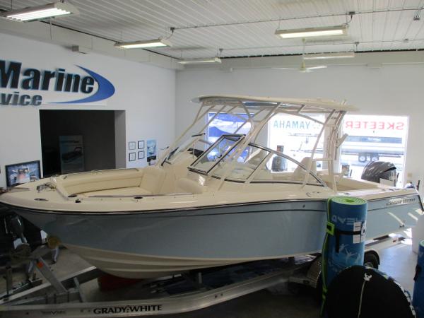 Slide: The Image of 2023 Grady-White Freedom 235 boat displayed in a showroom. - 0