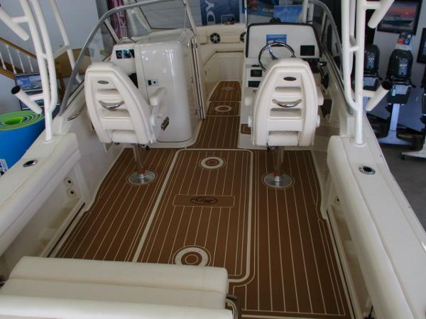 Slide: The Image of 2023 Grady-White Freedom 235 boat interior with white seats and brown deck. - 2