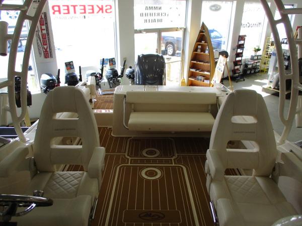 Slide: The Image of Interior of 2023 Grady-White Freedom 235 boat with seating and wooden flooring. - 5