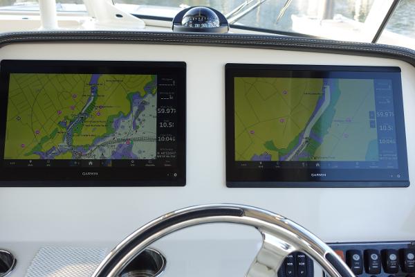 Slide: The Image of Dual Garmin displays on 2021 Grady-White Freedom 325 boat dashboard. - 20