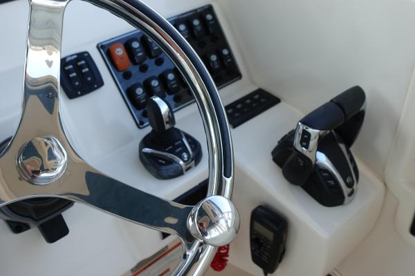 Slide: The Image of Steering console of 2021 Grady-White Freedom 325 boat with controls and instruments. - 21