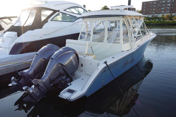 Slide: The Image of 2021 Grady-White Freedom 325 boat docked with twin Yamaha outboard engines. - 7