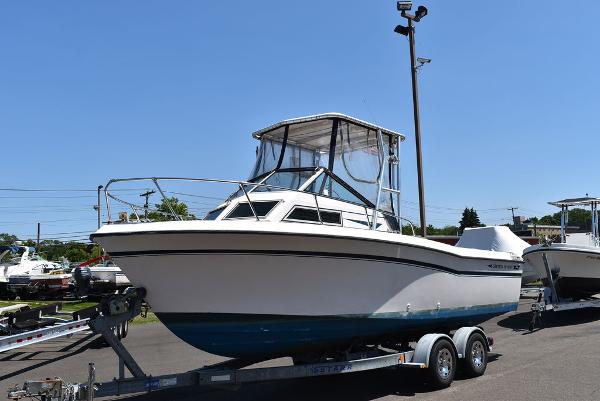 Slide: The Image of 1987 Grady-White Offshore 24 boat on a trailer in a marina. - 1