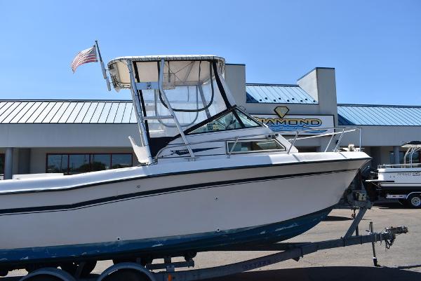 Slide: The Image of 1987 Grady-White Offshore 24 boat on trailer outside dealership. - 2