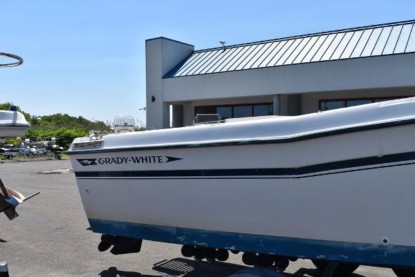 Slide: The Image of 1987 Grady-White Offshore 24 boat on a trailer outside a building. - 25