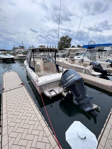 Slide: The Image of 2009 Grady-White Tournament 225 boat docked with Yamaha outboard motor. - 1