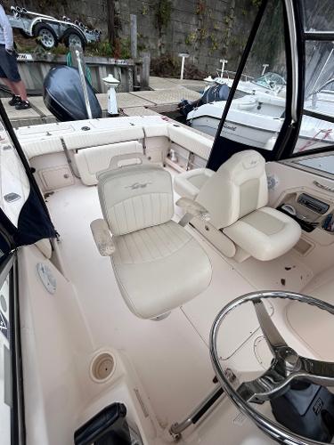 Slide: The Image of 2009 Grady-White Tournament 225 boat interior with white seating and steering wheel. - 4