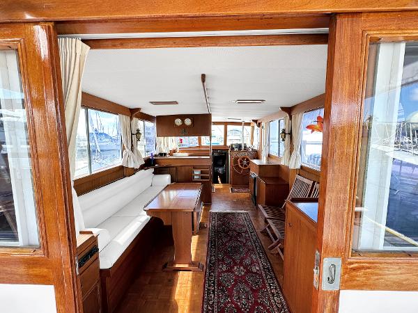 Slide: The Image of Interior of 1980 Grand Banks 42 Europa yacht with wooden furnishings and seating area. - 28