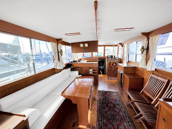 Slide: The Image of Interior of 1980 Grand Banks 42 Europa yacht with wooden furnishings and large windows. - 29
