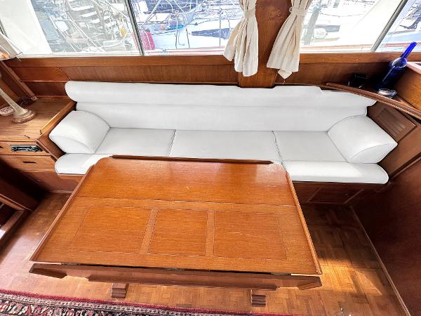 Slide: The Image of Interior of 1980 Grand Banks 42 Europa with white sofa and wooden table. - 31