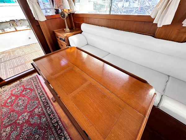 Slide: The Image of Interior of 1980 Grand Banks 42 Europa with wooden table and white sofa. - 32