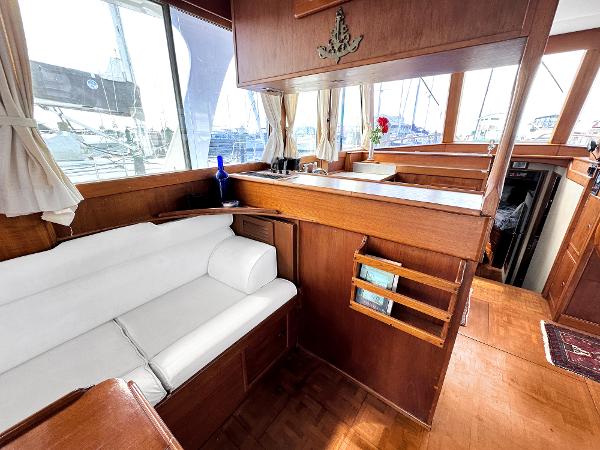 Slide: The Image of Interior of 1980 Grand Banks 42 Europa yacht with wooden finish and white seating. - 33