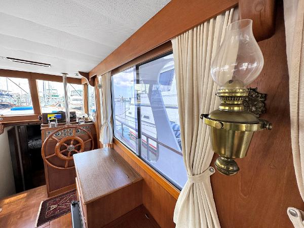 Slide: The Image of Interior of 1980 Grand Banks 42 Europa yacht with wooden helm and vintage lamp. - 35