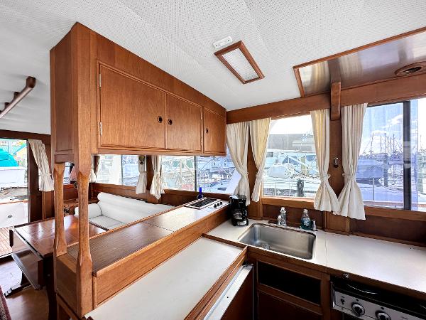 Slide: The Image of Interior of 1980 Grand Banks 42 Europa yacht with wooden cabinetry and kitchen area. - 41