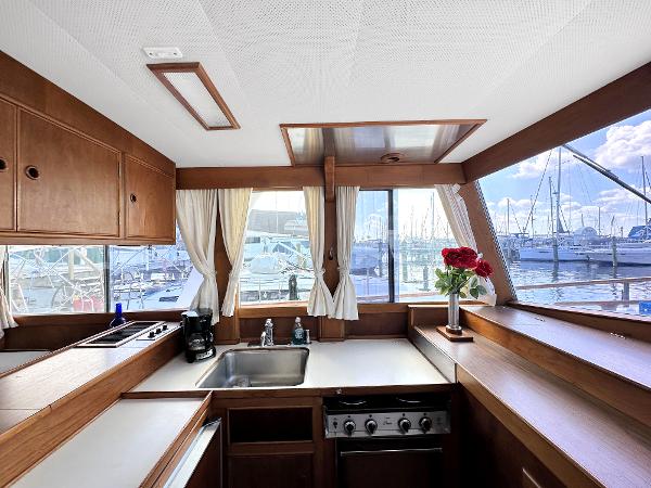Slide: The Image of Interior of 1980 Grand Banks 42 Europa yacht kitchen with marina view. - 43