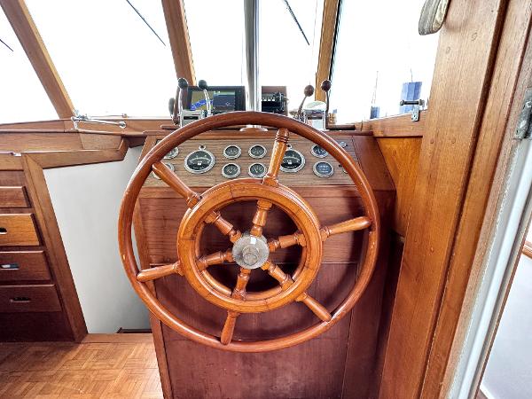 Slide: The Image of Wooden helm of 1980 Grand Banks 42 Europa yacht with classic gauges. - 45