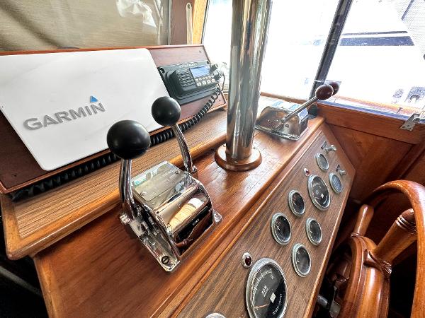 Slide: The Image of Vintage 1980 Grand Banks 42 Europa helm with Garmin navigation and classic wooden dashboard. - 46