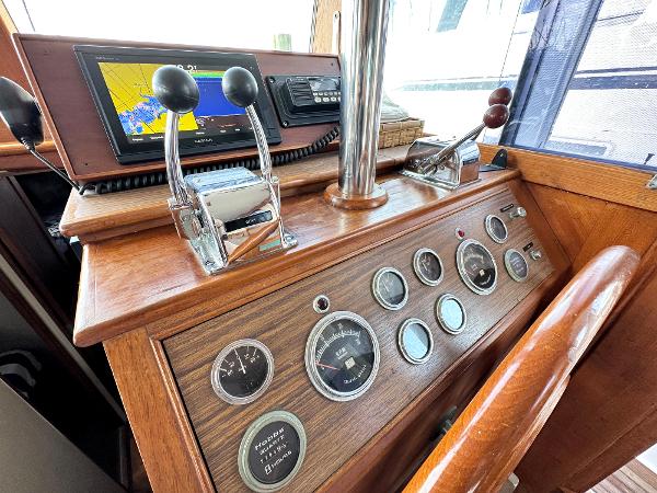 Slide: The Image of Control panel of a 1980 Grand Banks 42 Europa boat with gauges and navigation equipment. - 47