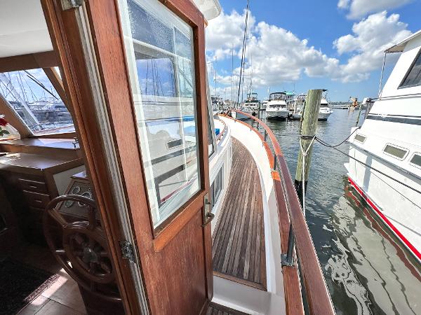 Slide: The Image of 1980 Grand Banks 42 Europa yacht docked at marina under blue sky. - 49