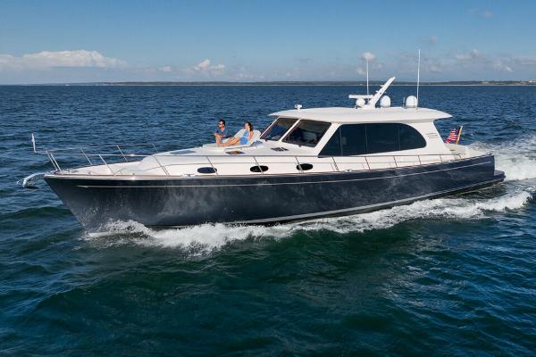 Slide: The Image of 2023 Eastbay EB60 yacht cruising on open water under clear skies. - 0
