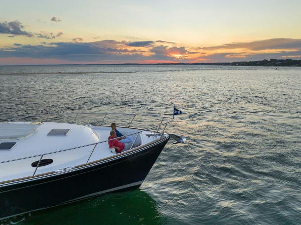 Slide: The Image of Eastbay EB60 yacht cruising at sunset, 2023 model, serene ocean view. - 14