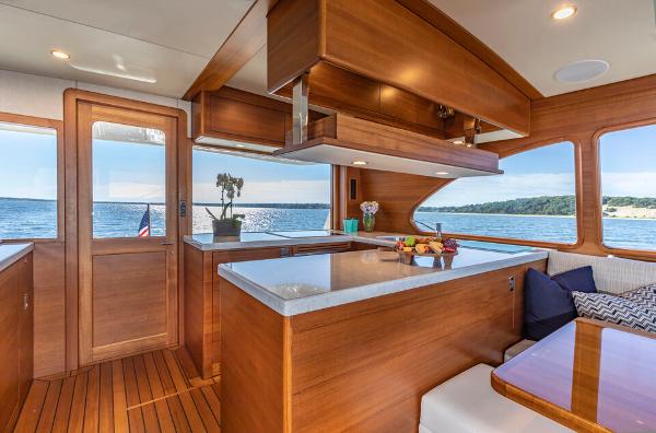 Slide: The Image of Luxurious 2023 Eastbay EB60 yacht interior with wooden finishes and ocean view. - 2