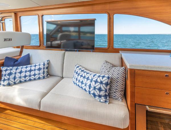 Slide: The Image of Luxurious Eastbay EB60 yacht interior with ocean view, featuring a comfortable sofa and stylish cushions. - 22