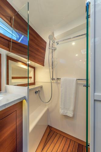 Slide: The Image of Luxurious Eastbay EB60 2023 yacht bathroom with wood accents and modern shower. - 23