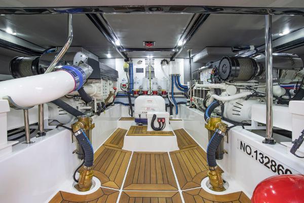Slide: The Image of Engine room of 2023 Eastbay EB60 yacht with modern equipment and wooden flooring. - 26