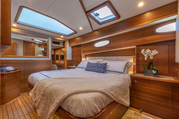 Slide: The Image of Luxurious Eastbay EB60 yacht bedroom, 2023 model, with elegant wood finishes and skylight. - 3
