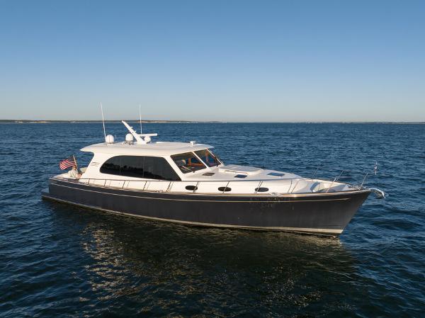 Slide: The Image of 2023 Eastbay EB60 yacht cruising on open water under clear blue sky. - 30