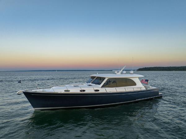 Slide: The Image of 2023 Eastbay EB60 yacht cruising on serene waters at sunset. - 31