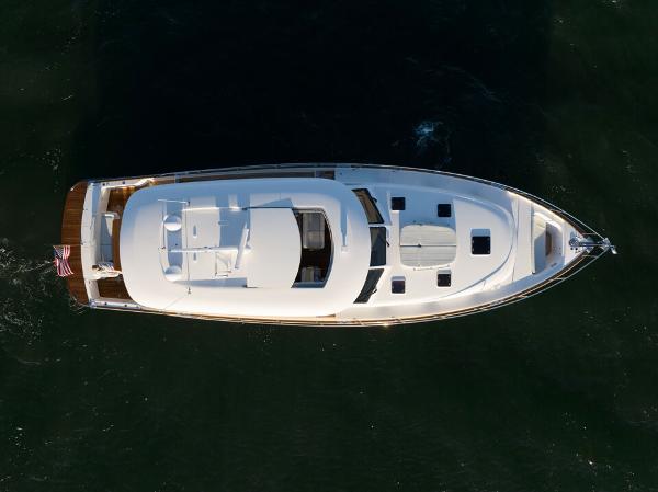 Slide: The Image of Aerial view of 2023 Eastbay EB60 yacht cruising on open water. - 6