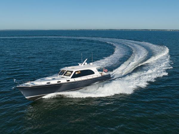 Slide: The Image of 2023 Eastbay EB60 yacht cruising on open water, leaving a wake trail. - 8