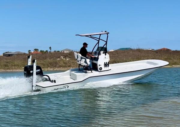 Slide: The Image of 2024 Gulf Coast VariSide boat cruising on water with a person at the helm. - 1
