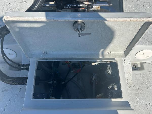 Slide: The Image of 2024 Gulf Coast VariSide boat compartment with open hatch and visible wiring. - 24