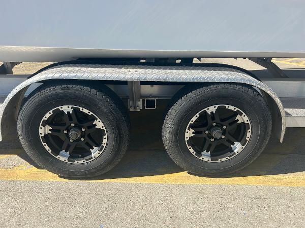 Slide: The Image of 2024 Gulf Coast VariSide trailer with dual black alloy wheels. - 26