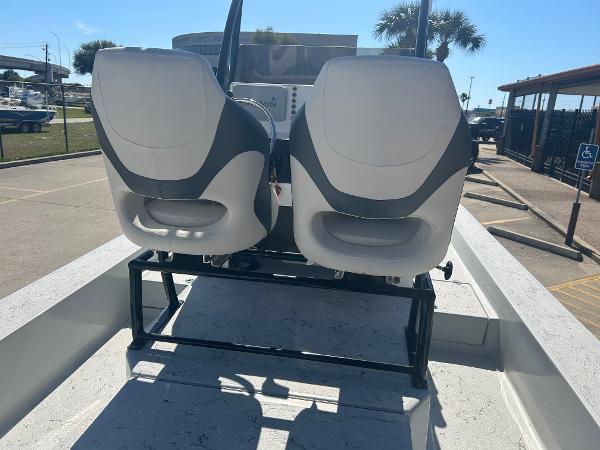 Slide: The Image of 2024 Gulf Coast VariSide boat with dual seats and console, parked outdoors. - 27