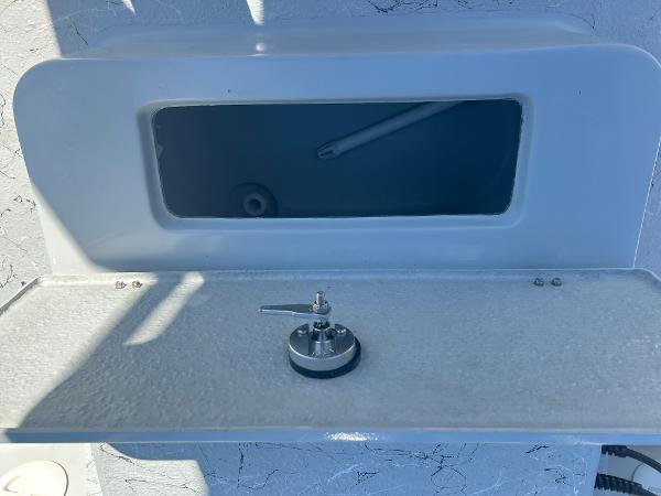 Slide: The Image of 2024 Gulf Coast VariSide boat storage compartment with latch and open lid. - 30