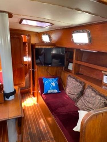 Slide: The Image of 1978 Gulfstar 50 yacht interior with wooden furnishings and cozy seating area. - 11