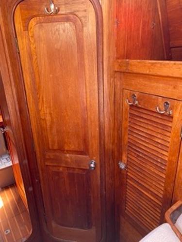 Slide: The Image of 1978 Gulfstar 50 interior wooden cabin door and storage area. - 17