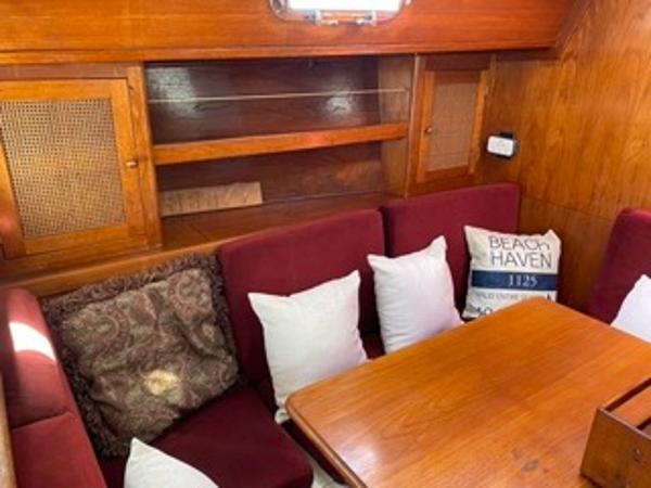 Slide: The Image of 1978 Gulfstar 50 yacht interior with wooden cabinetry and cushioned seating. - 18