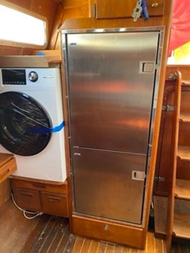 Slide: The Image of 1978 Gulfstar 50 yacht interior with washer and stainless steel fridge. - 26
