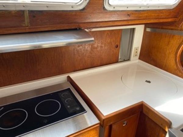 Slide: The Image of 1978 Gulfstar 50 yacht kitchen with electric stove and wooden cabinetry. - 30