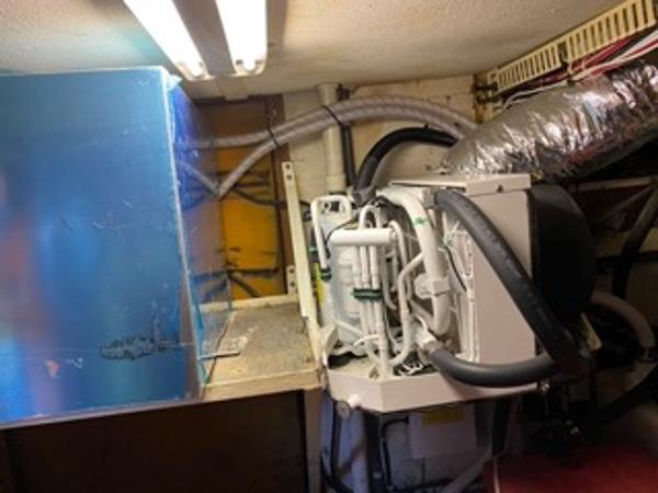 Slide: The Image of 1978 Gulfstar 50 engine room with mechanical components and ductwork. - 39
