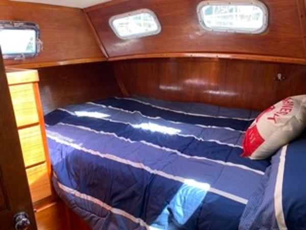 Slide: The Image of 1978 Gulfstar 50 yacht cabin with cozy bed and wooden interior. - 42