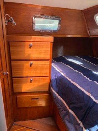 Slide: The Image of 1978 Gulfstar 50 yacht cabin with wooden drawers and bed. - 43