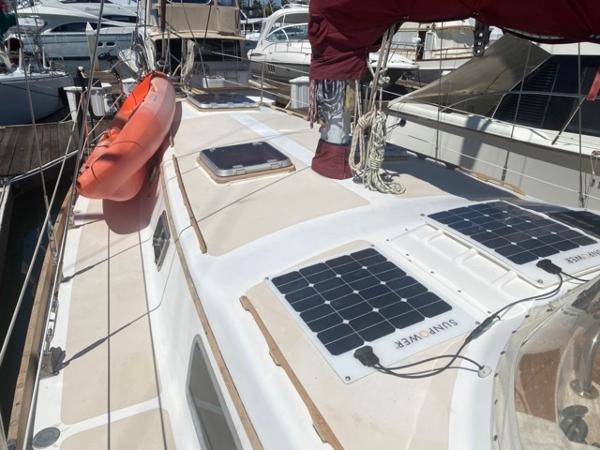Slide: The Image of 1978 Gulfstar 50 sailboat with solar panels and lifeboat docked at marina. - 8